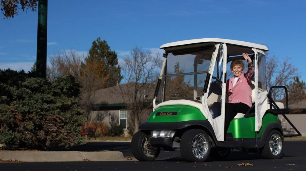 ER Senior Management | Resident waving from golf cart