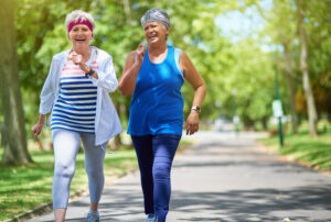Shot of two senior friends enjoying a run together outdoors