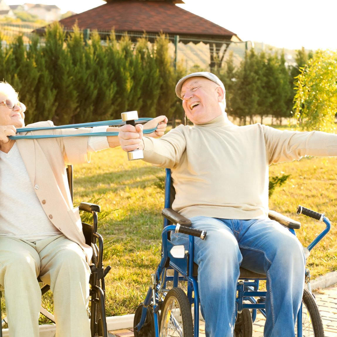Senior man and woman from care home doing exercise outdoors